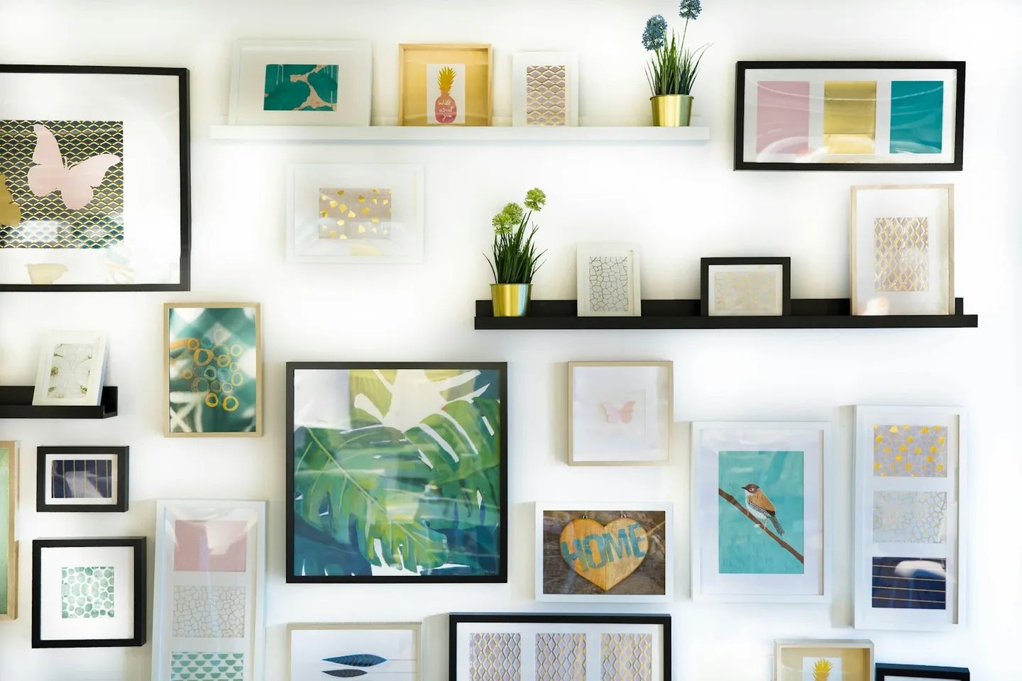 Framed pictures arranged together on an interior wall