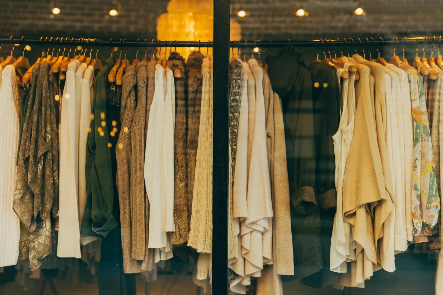 Clothing displayed on hangers inside a fashion store