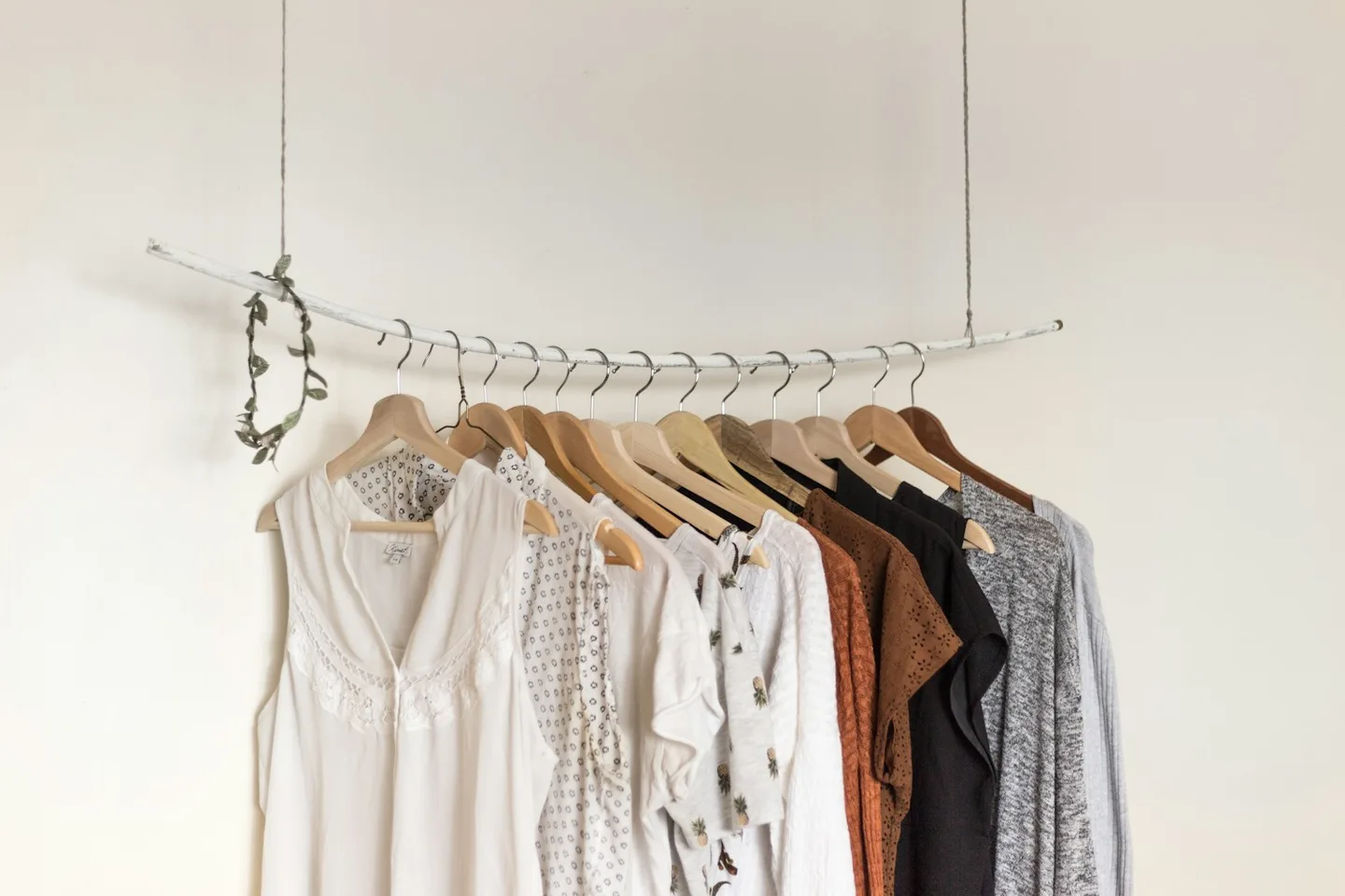 Light neutral clothes hanging on a rail