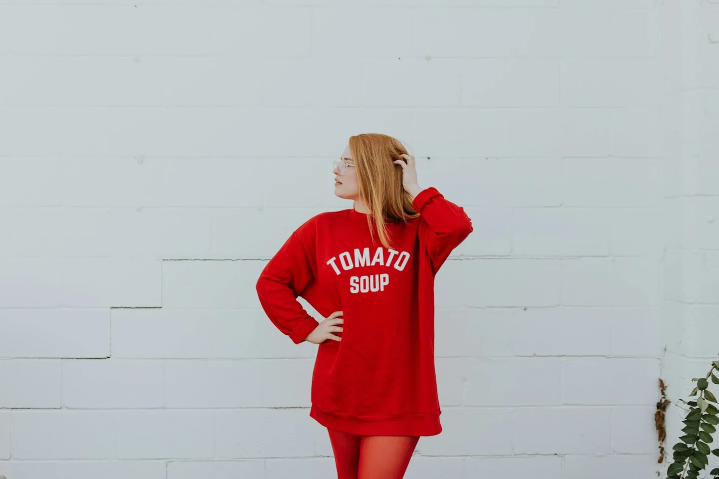 Back view of a woman wearing a long red knit layer