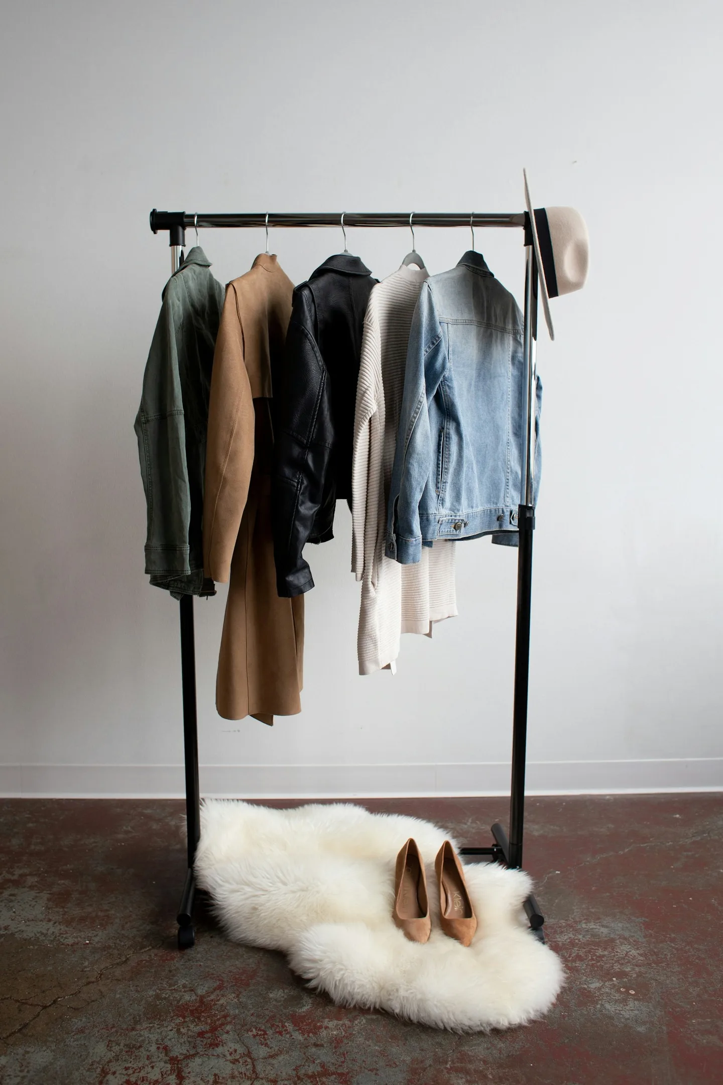 Coats and jeans hanging together in a wardrobe